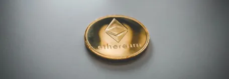 A golden coin that says 'ethereum'.