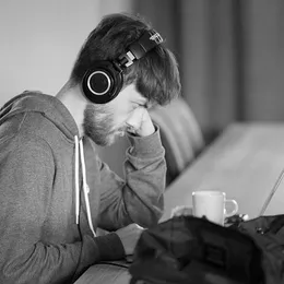 One of our employees sits concentrated in front of his laptop wearing headphones.